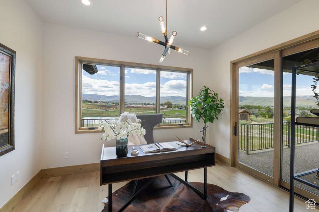 Office area with a chandelier, light wood-style flooring, recessed lighting, baseboards, and a mountain view