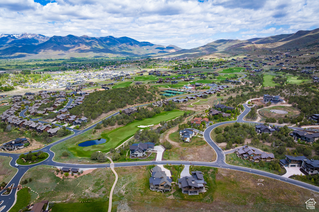 Aerial view of property's location with nearby suburban area and a water and mountain view