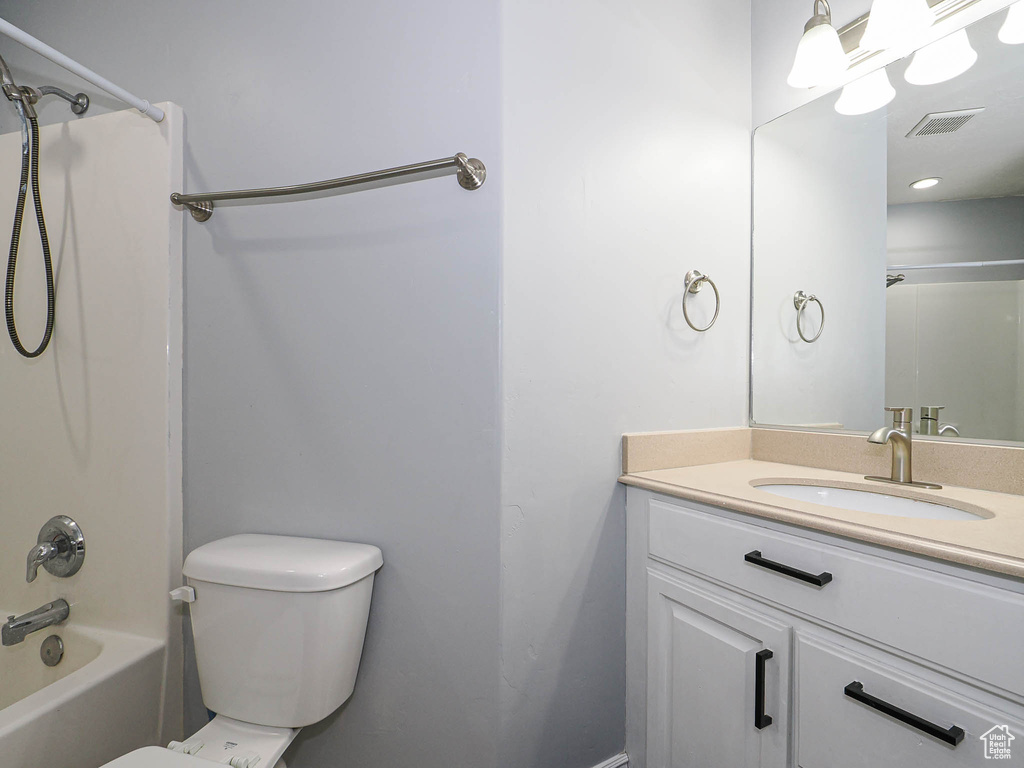 Full bathroom with vanity, shower / tub combination, and toilet