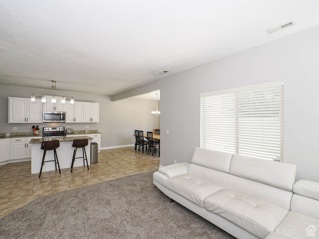 Living area with a chandelier and baseboards