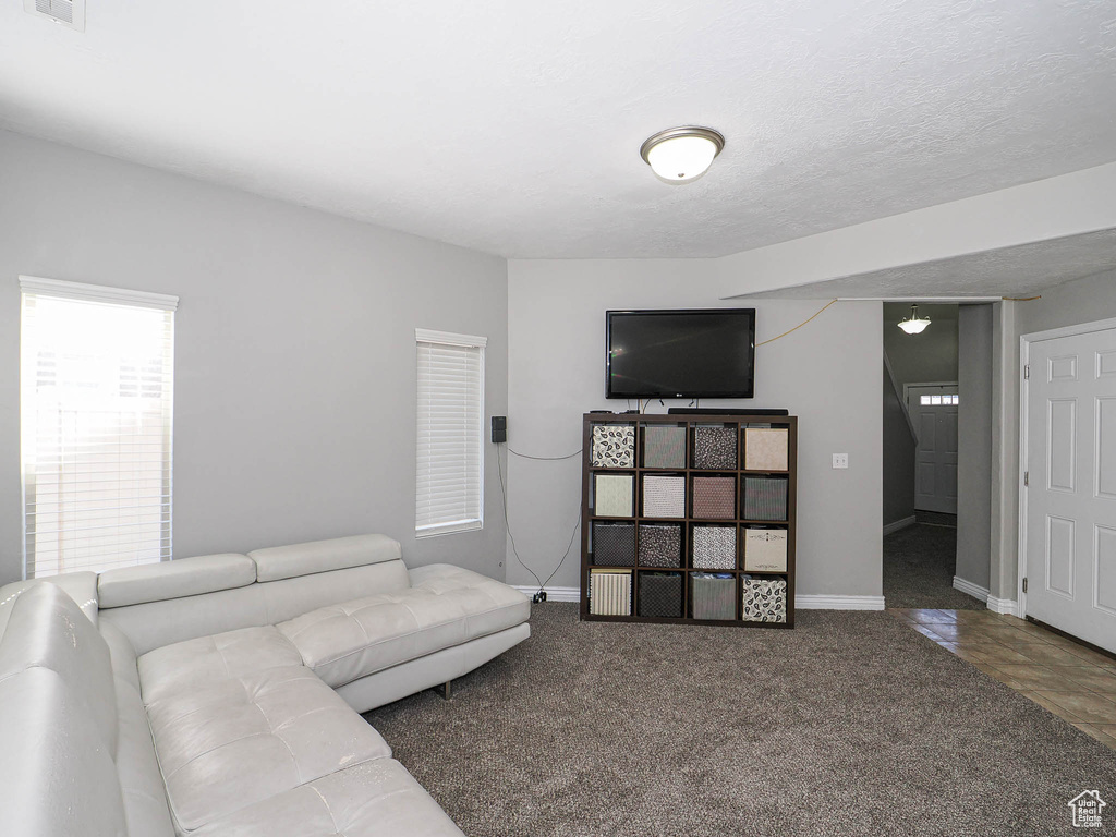 Carpeted living area featuring baseboards