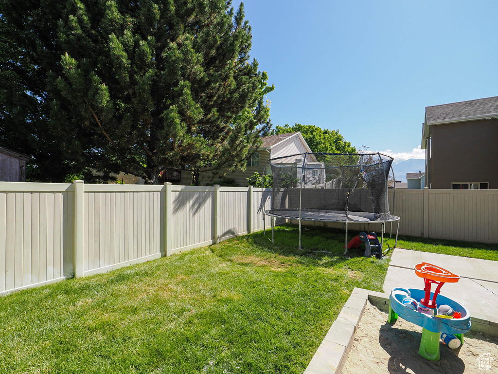 View of yard with a trampoline