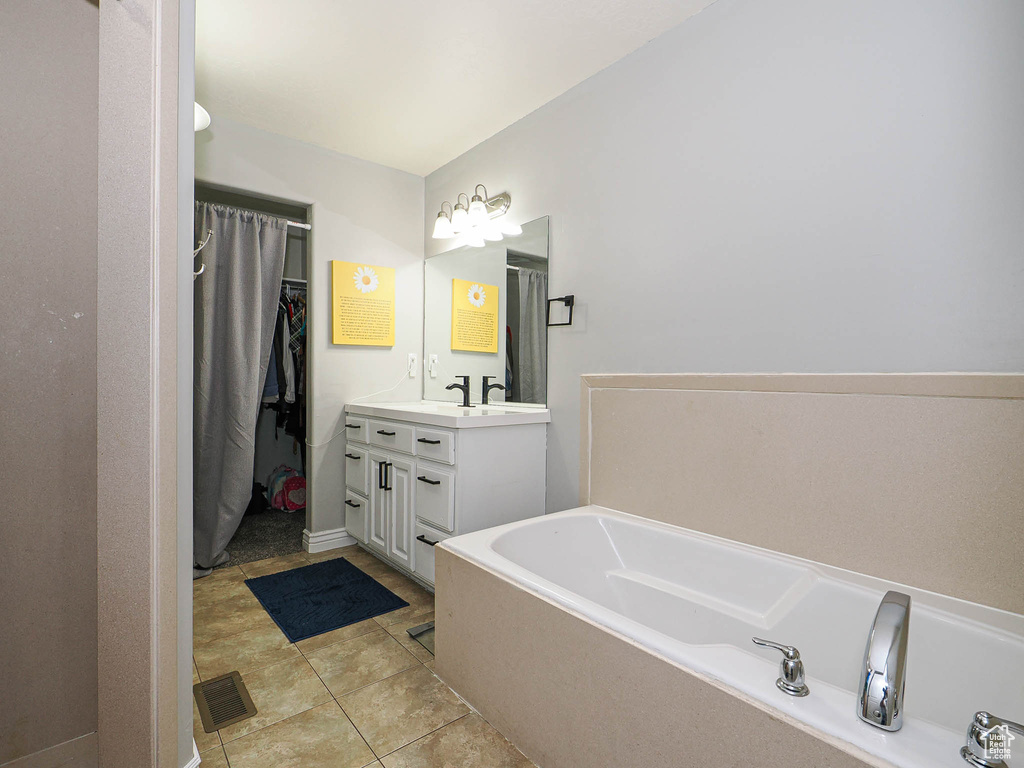 Full bathroom featuring vanity, a bath, tile patterned flooring, and a shower with curtain