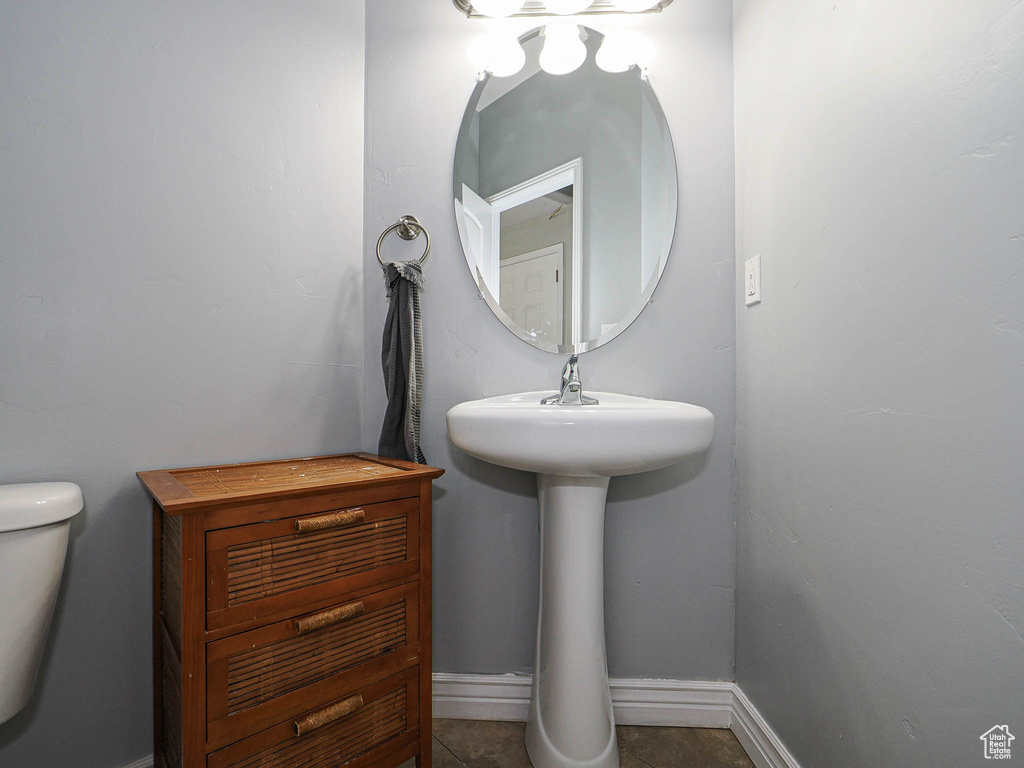 Bathroom featuring toilet and baseboards