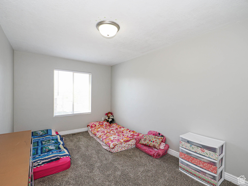 Unfurnished bedroom with baseboards and carpet flooring