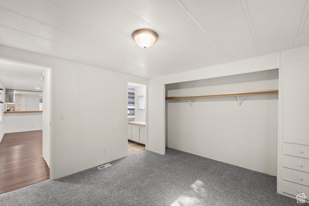Unfurnished bedroom featuring carpet and a closet