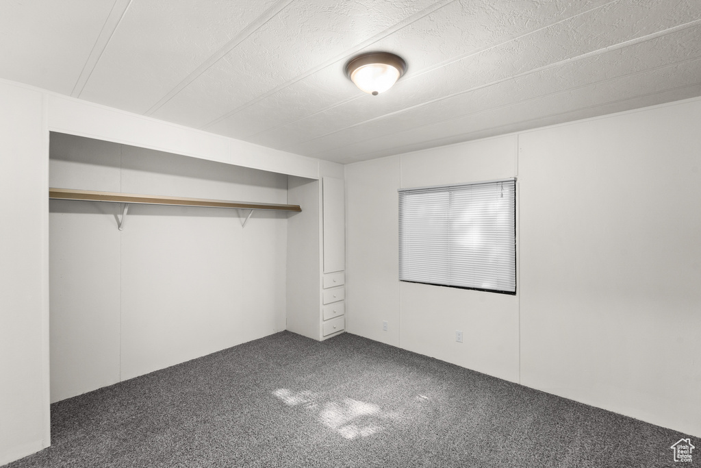 Unfurnished bedroom with carpet floors and a closet