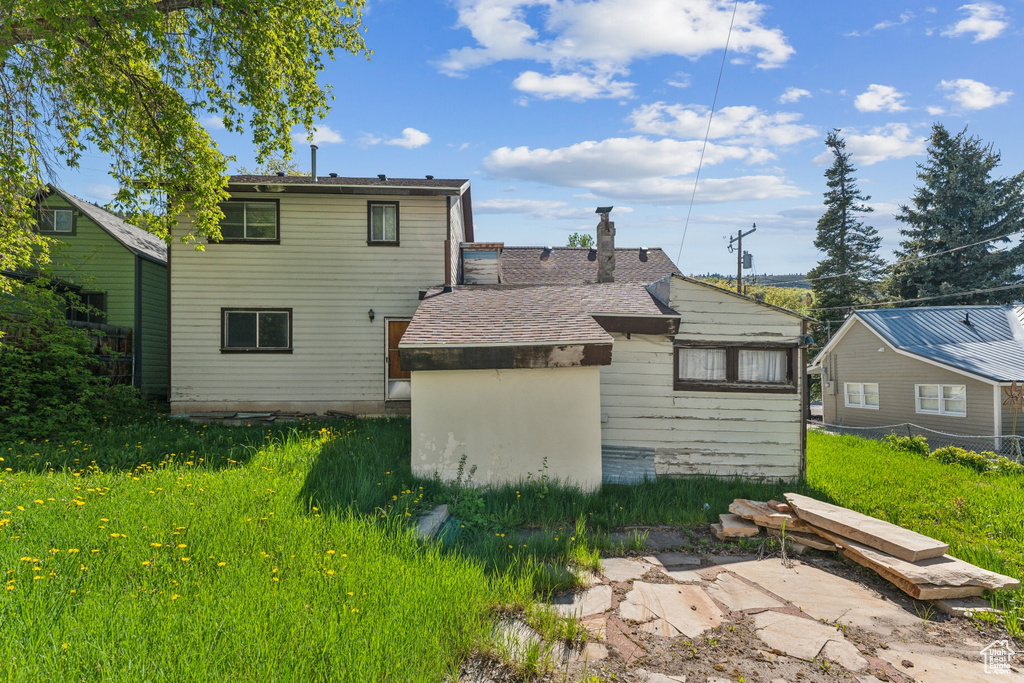 Rear view of house featuring a chimney