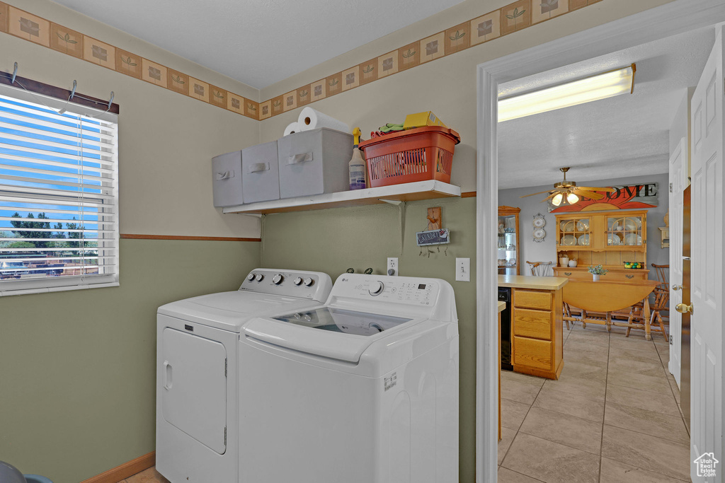 Laundry area with separate washer and dryer, a ceiling fan, and light tile patterned flooring