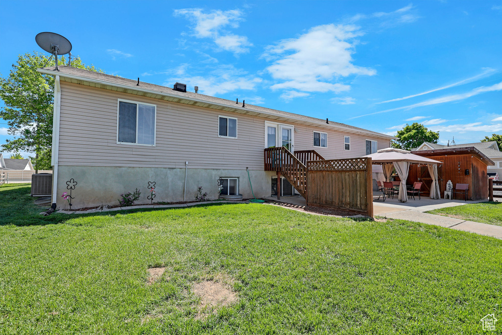 Back of house featuring a gazebo, a patio area, a yard, and central air condition unit