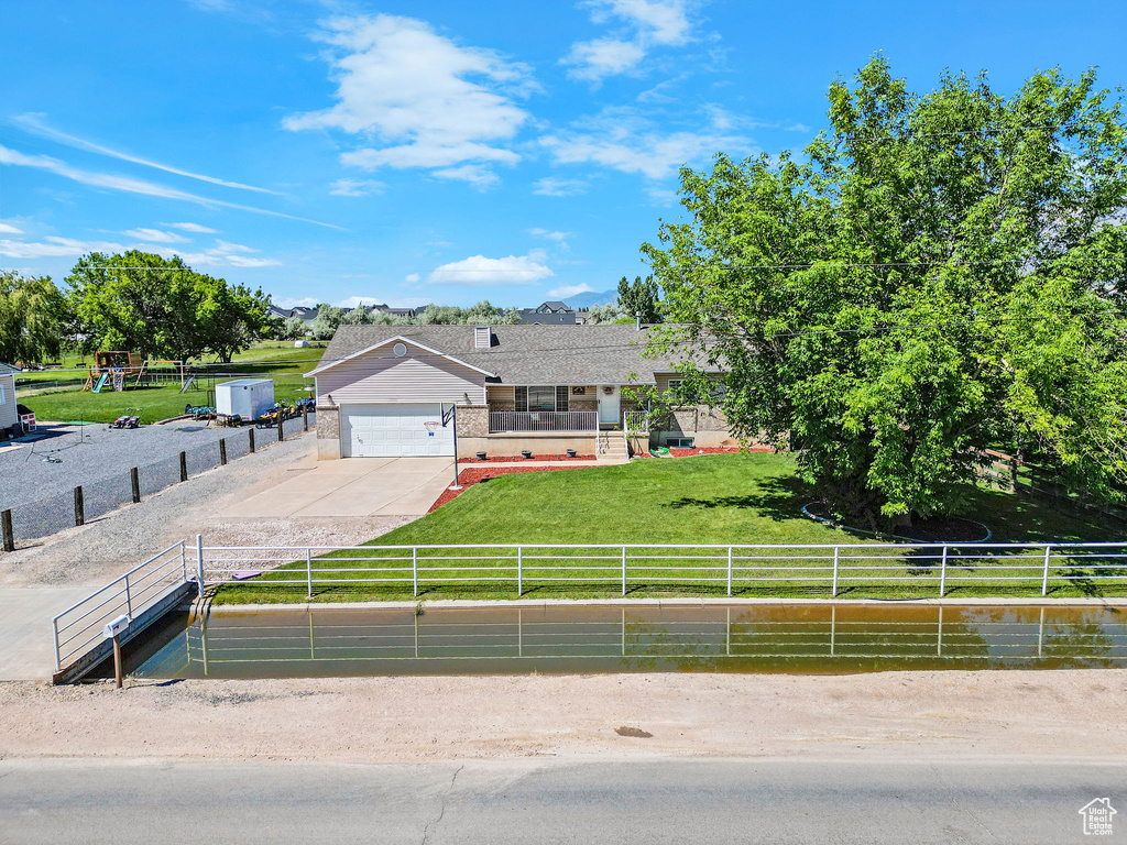 View of front of property featuring driveway, a garage, and brick siding