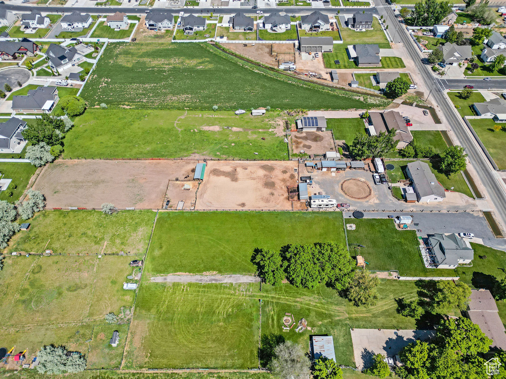 Aerial view of property and surrounding area with nearby suburban area