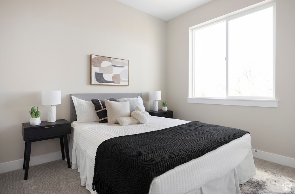 Bedroom featuring carpet flooring and baseboards