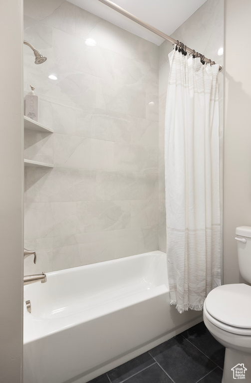 Full bathroom featuring tile patterned flooring, shower / bath combo, and toilet