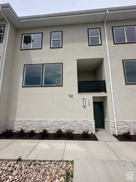 View of front of home with stucco siding and stone siding