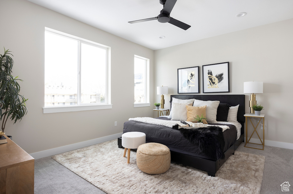 Carpeted bedroom featuring baseboards and a ceiling fan