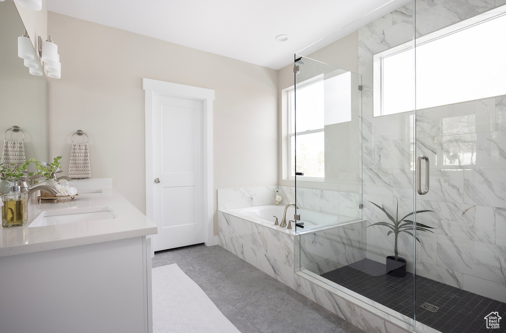 Bathroom with a garden tub, a marble finish shower, and double vanity
