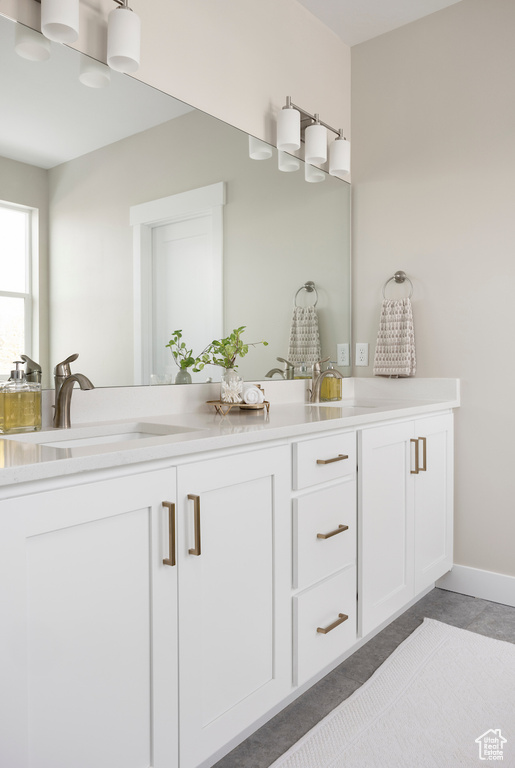 Full bathroom with double vanity and tile patterned flooring