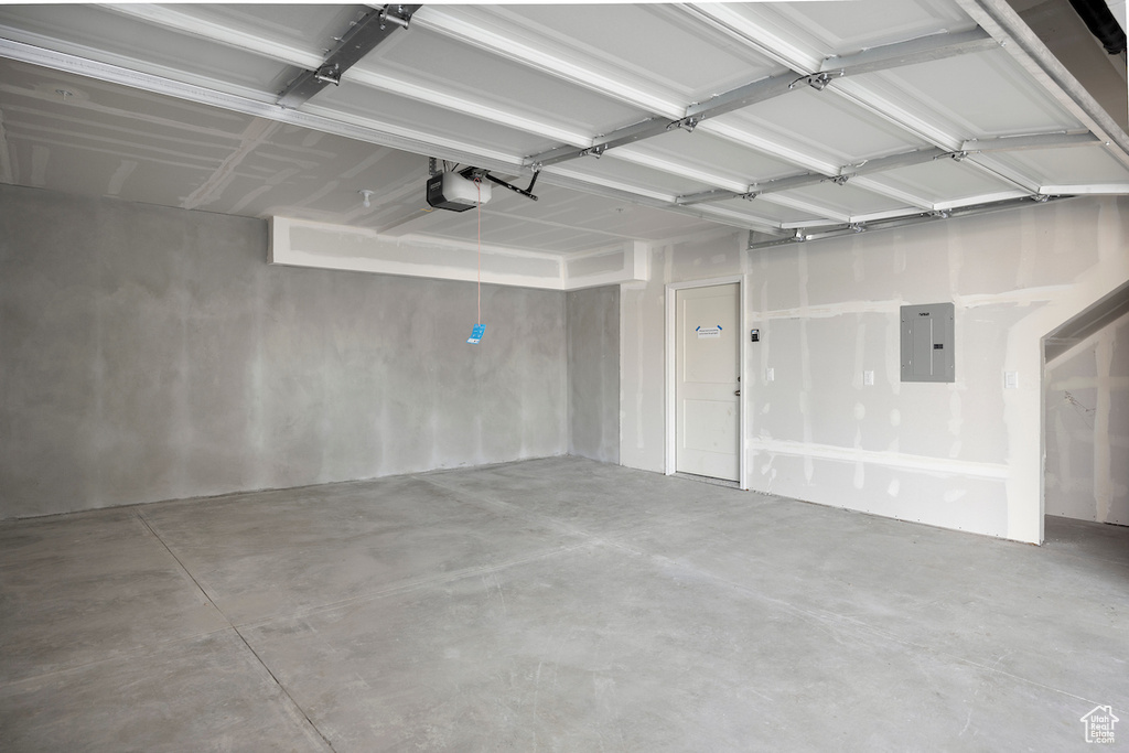 Garage with electric panel and a garage door opener