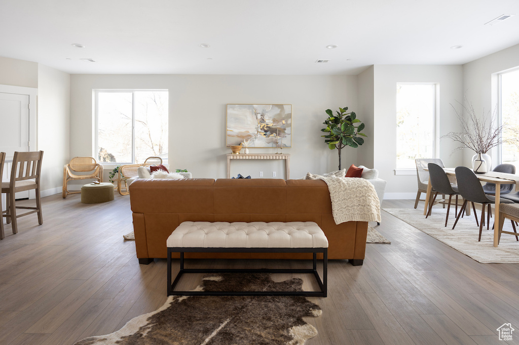Living area with light wood-style flooring, baseboards, and recessed lighting