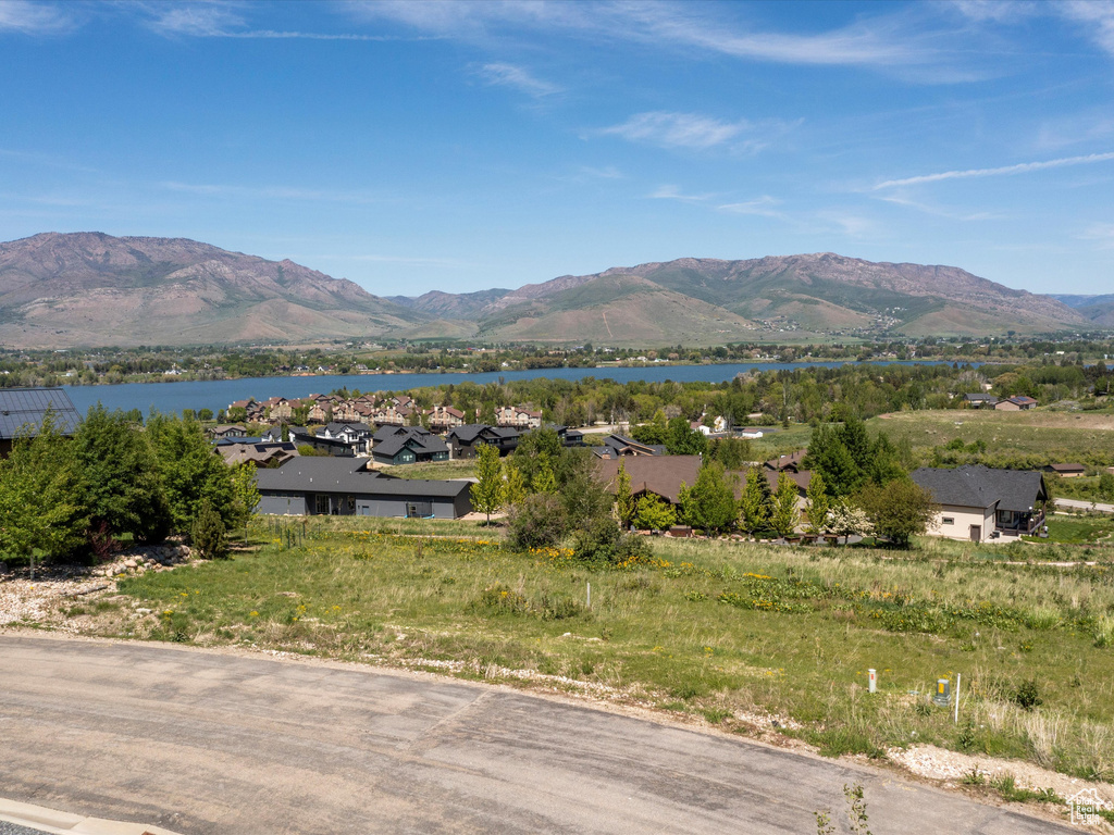 View of mountain backdrop with a nearby body of water and nearby suburban area