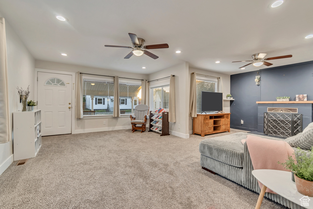Living area with ceiling fan, recessed lighting, carpet flooring, and baseboards