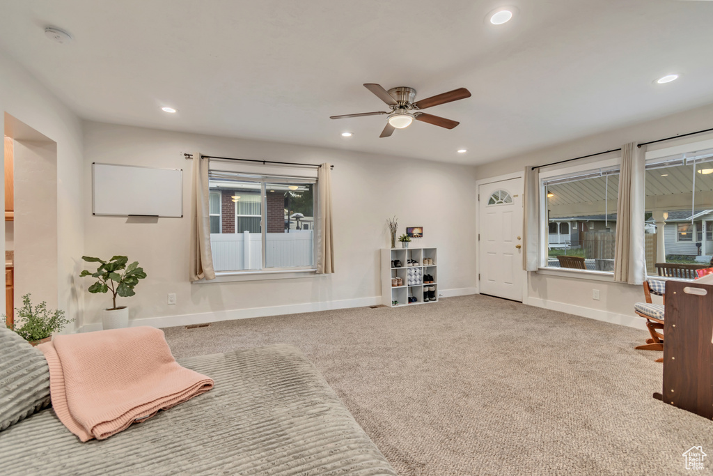 Living area with a ceiling fan, recessed lighting, baseboards, and carpet flooring