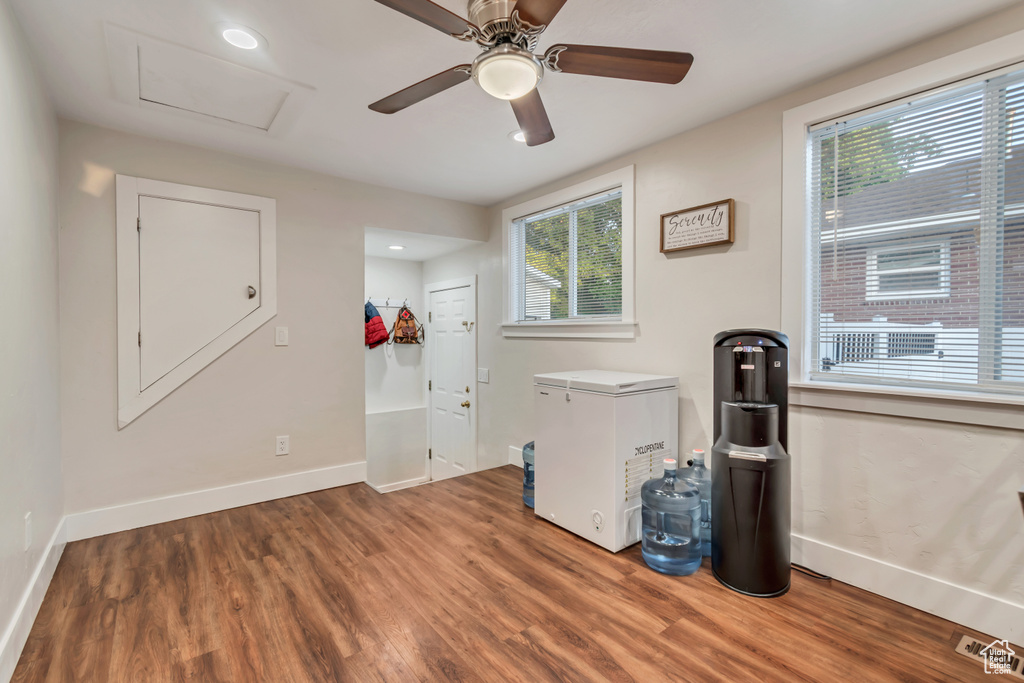 Spare room with healthy amount of natural light, wood finished floors, baseboards, and recessed lighting