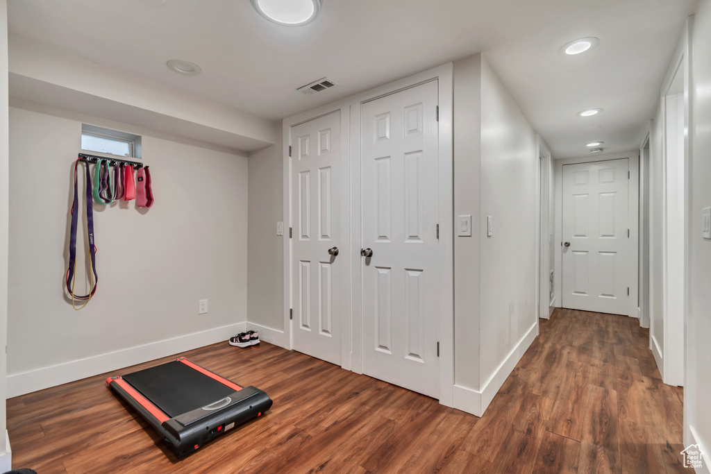 Workout room with baseboards, wood finished floors, and recessed lighting