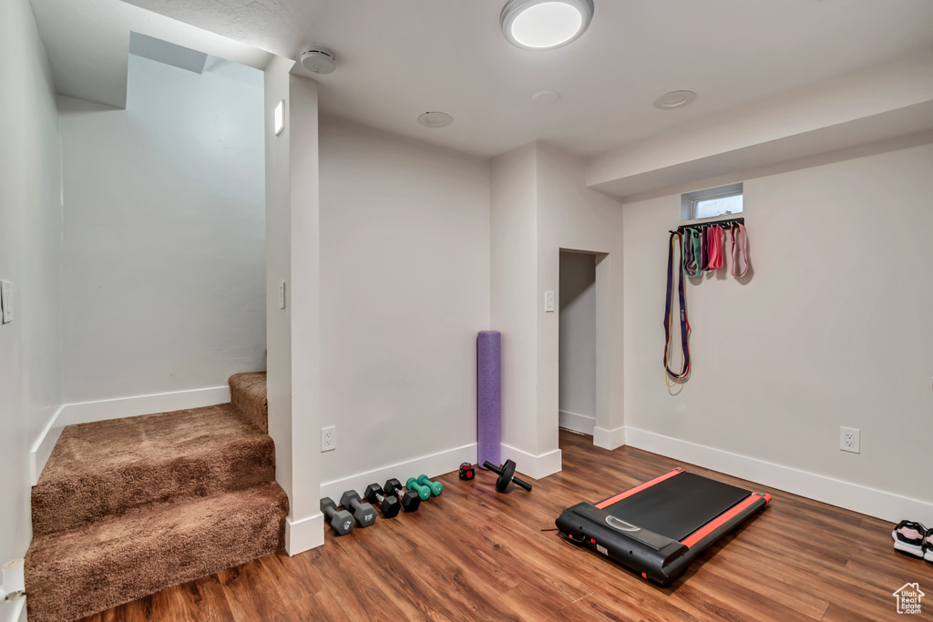 Exercise area featuring wood finished floors and baseboards