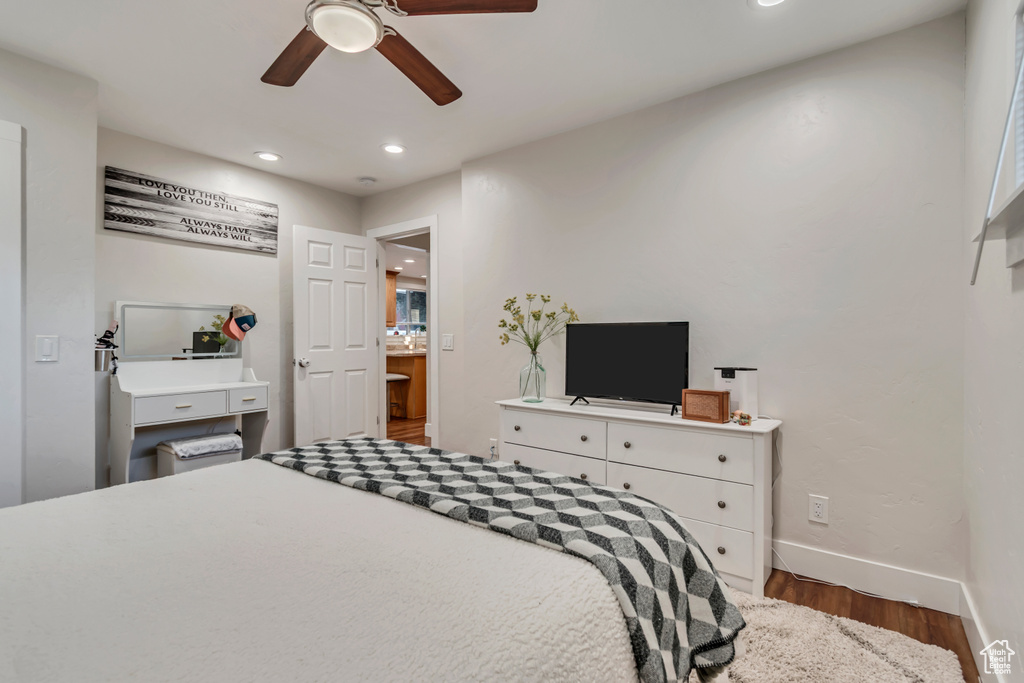 Bedroom featuring wood finished floors, baseboards, recessed lighting, and ceiling fan