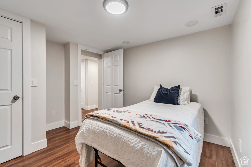 Bedroom featuring baseboards and dark wood-style floors