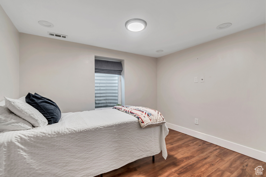 Bedroom featuring baseboards and dark wood-style flooring