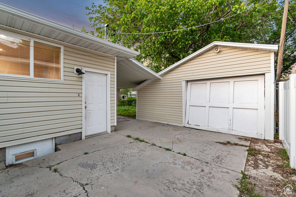 Detached garage featuring concrete driveway