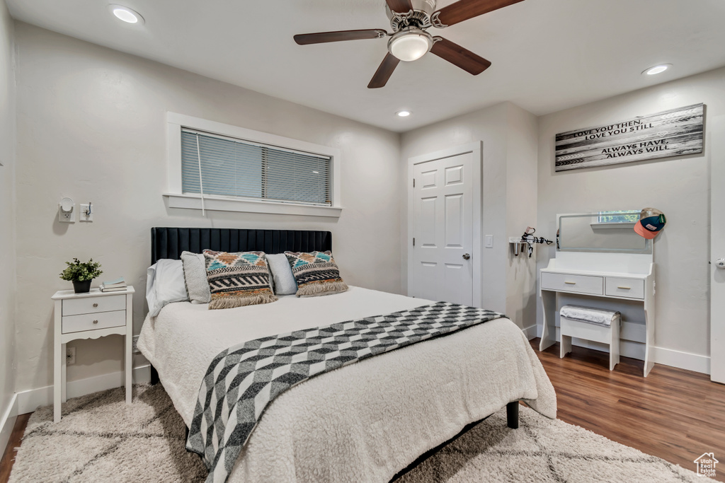 Bedroom with baseboards, wood finished floors, recessed lighting, and a ceiling fan