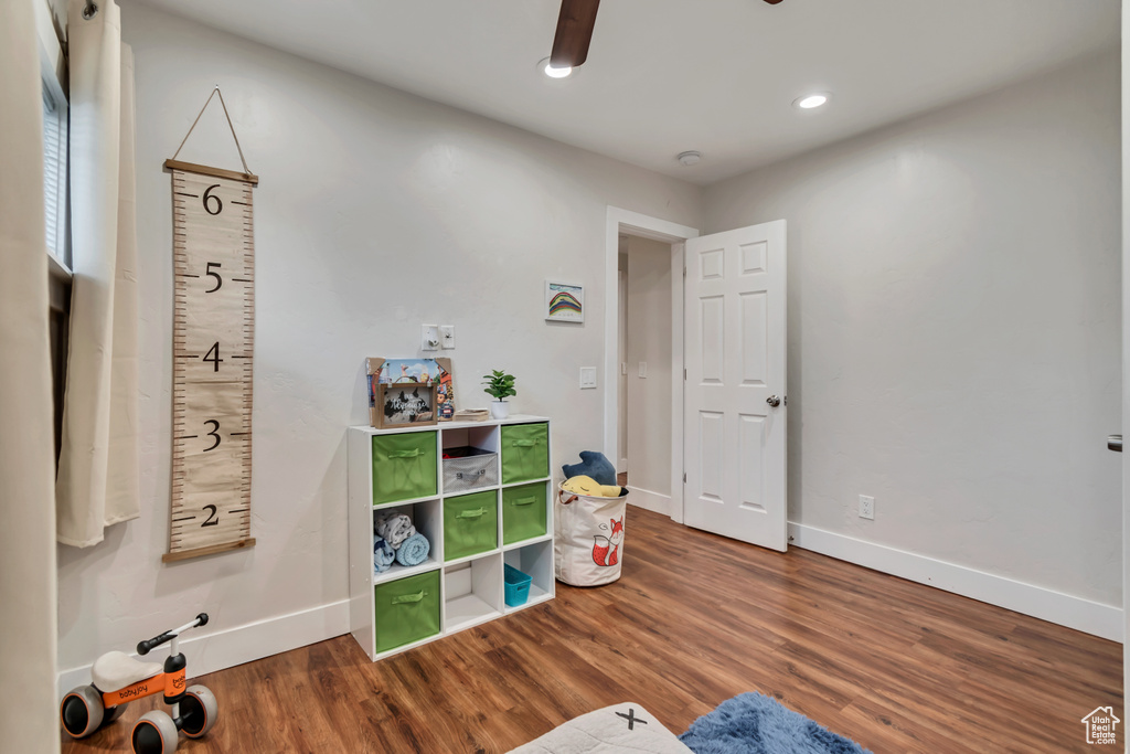 Game room with baseboards, wood finished floors, and recessed lighting