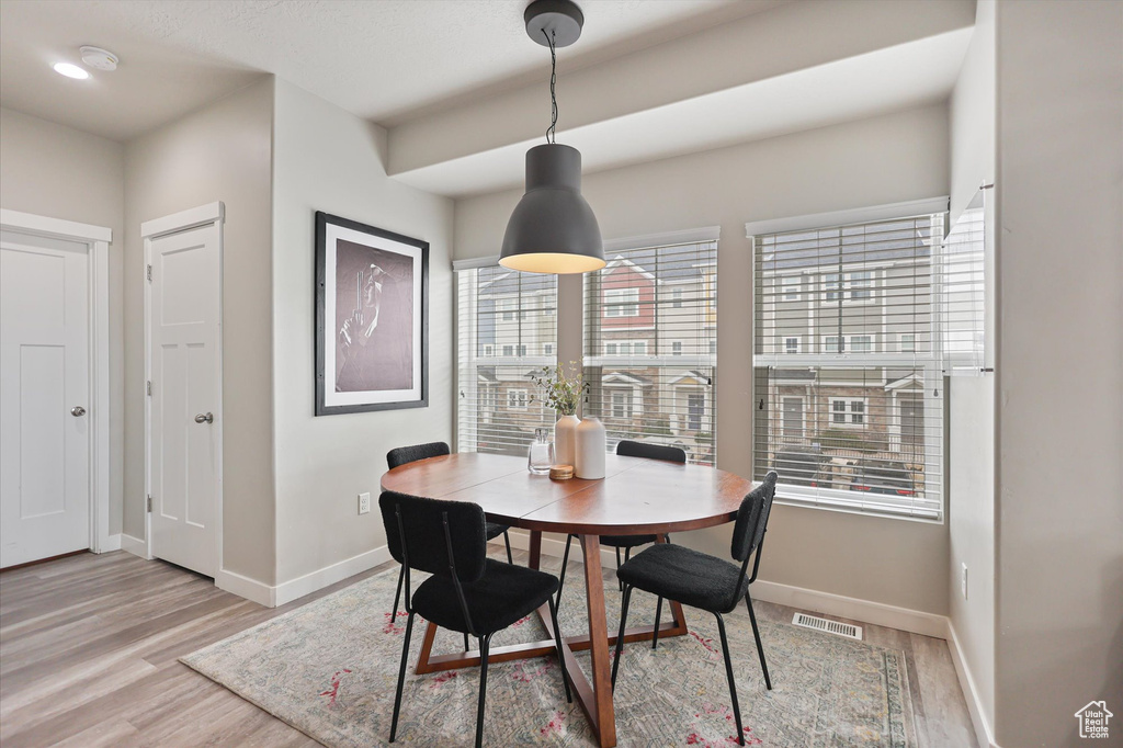Dining space with baseboards and light wood-type flooring
