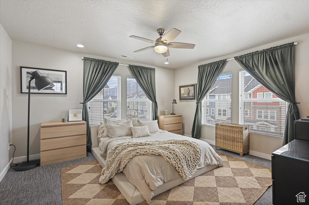 Bedroom with light colored carpet, baseboards, a textured ceiling, a ceiling fan, and recessed lighting
