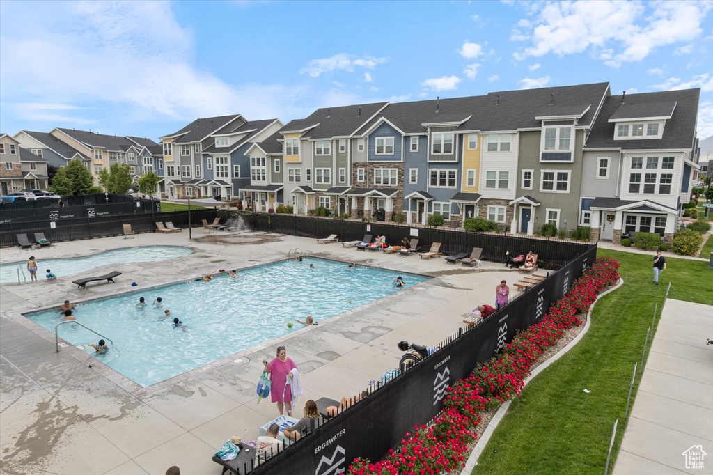 Community pool with a residential view and a patio area