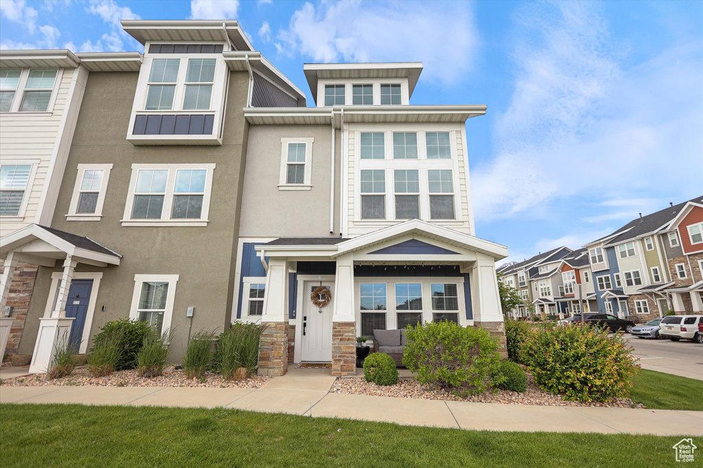 View of front of property with stone siding and stucco siding