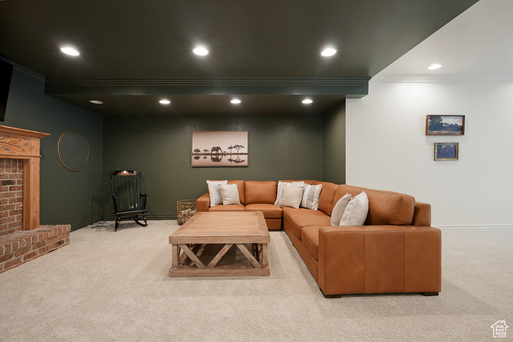 Living room with ornamental molding, light carpet, recessed lighting, and baseboards