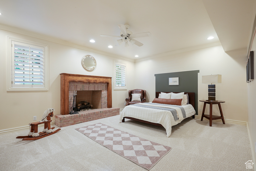 Bedroom featuring carpet flooring, ornamental molding, baseboards, a fireplace, and recessed lighting