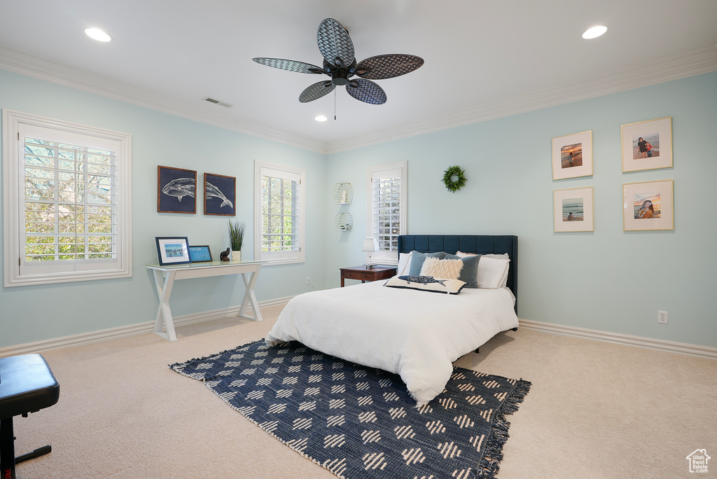 Carpeted bedroom with crown molding, recessed lighting, baseboards, and a ceiling fan