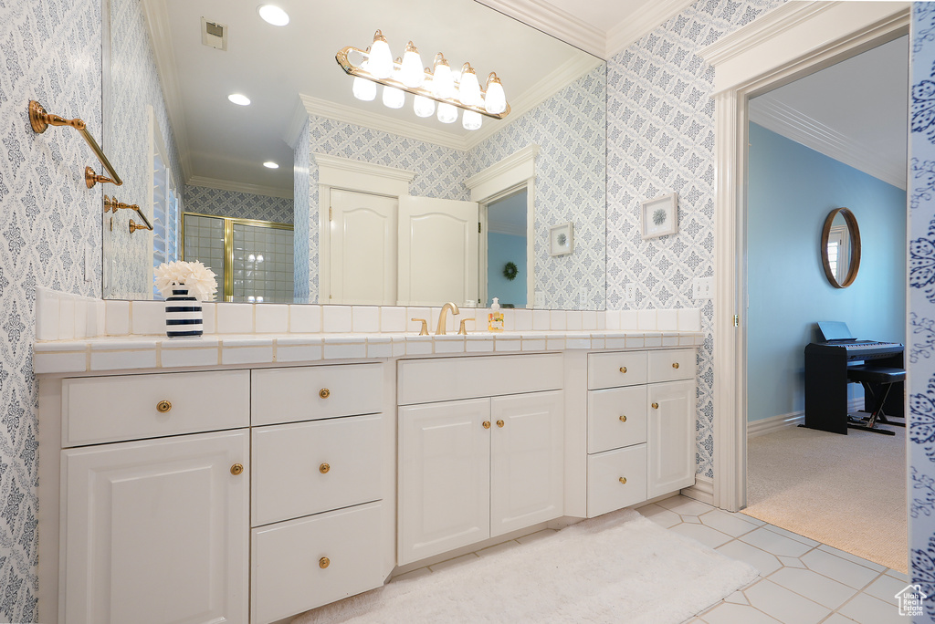Full bath featuring crown molding, wallpapered walls, a stall shower, vanity, and baseboards