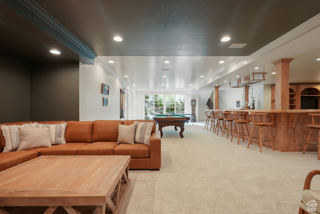Living area featuring light colored carpet, pool table, crown molding, recessed lighting, and bar area