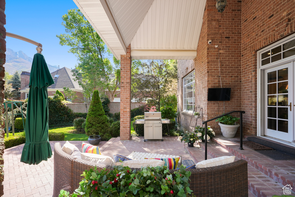 View of patio with an outdoor hangout area and grilling area