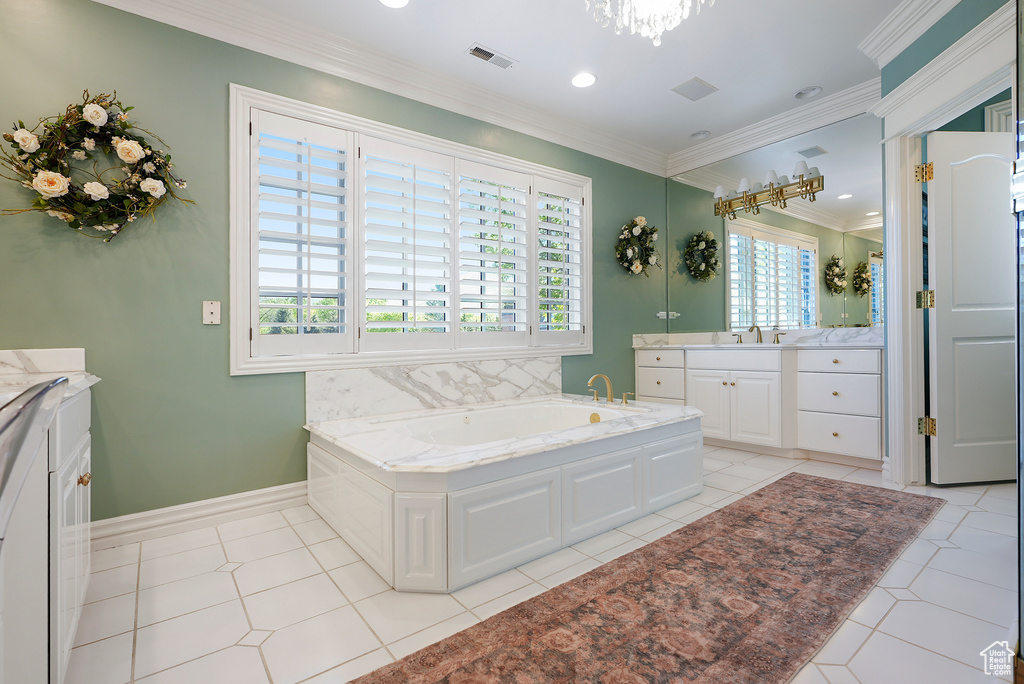 Bathroom with vanity, a bath, ornamental molding, baseboards, and tile patterned floors