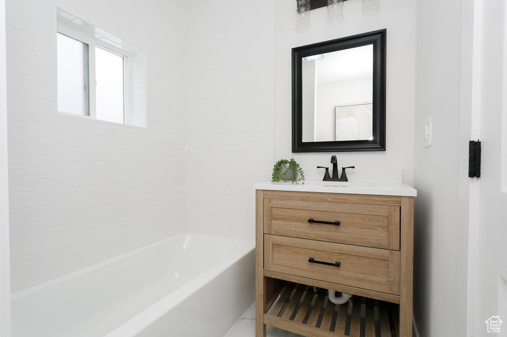 Bathroom with vanity and shower / bath combination