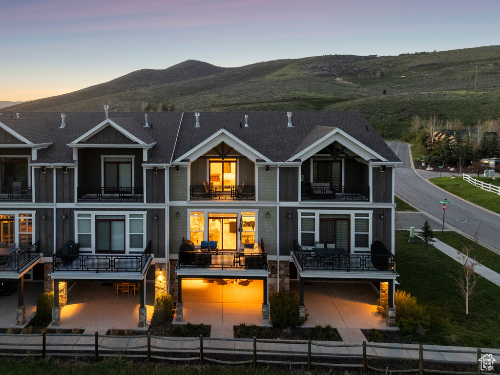 Rear view of house with a balcony and a mountain view