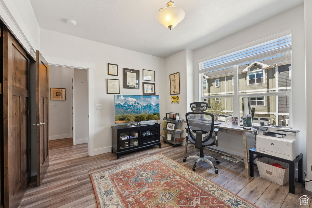 Office area with wood finished floors and baseboards
